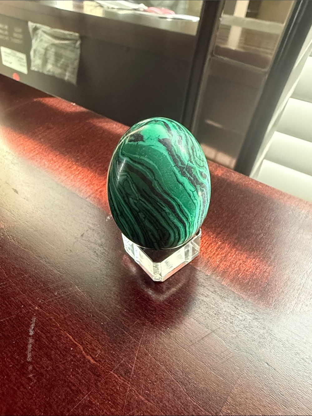Malachite polished stone egg with small acrylic stand